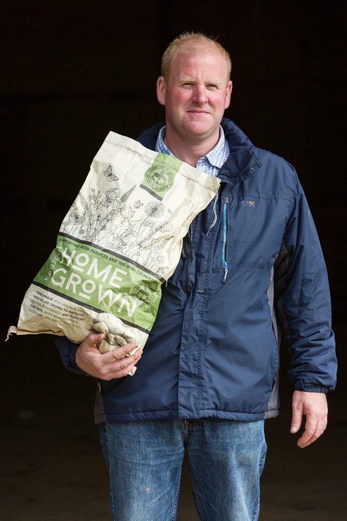 Photo of homegrown supplier holding bag of potatoes   Food Photographer Dublin commercial photography www.1image.ie