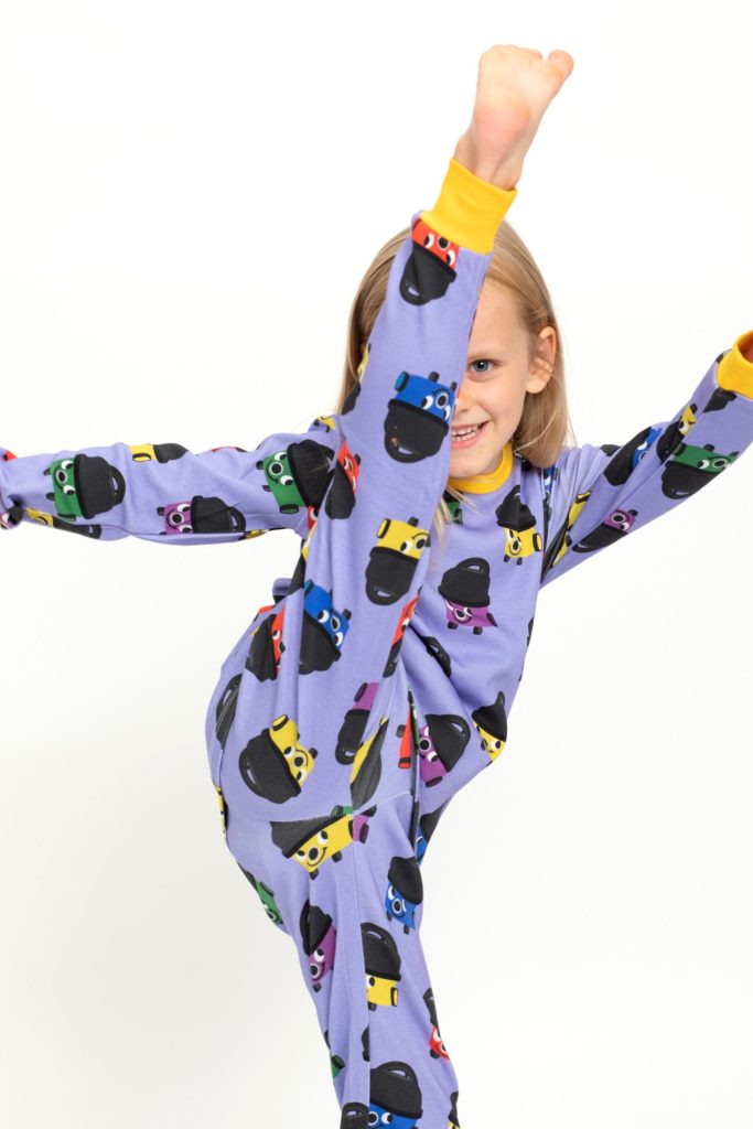 Young girl doing a high kick in Professional Photography Studio at a commercial product photography shoot for children's clothing company The Little One